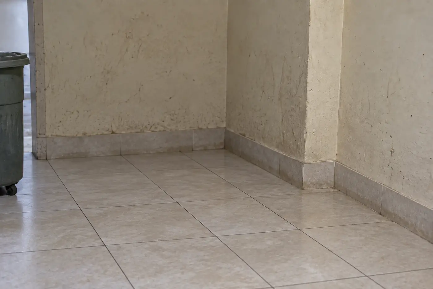 الركن نفسه بعد إخراج الأكياس وغسل الأرضية ورش أسفل الجدار